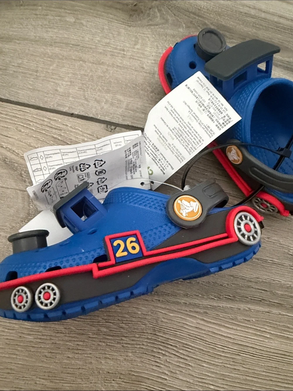 CROCS Kids Clog in Blue with Red Trim and Black Badges